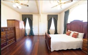 a bedroom with a bed and a dresser at Large King suit in Perth City (China town) with free Parking in a quiet and peaceful street in Perth