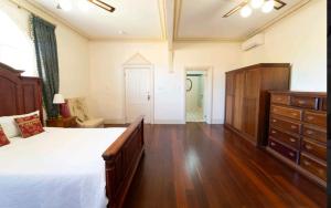 a large bedroom with a bed and a dresser at Large King suit in Perth City (China town) with free Parking in a quiet and peaceful street in Perth