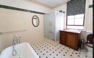 a bathroom with a tub and a shower and a sink at Large King suit in Perth City (China town) with free Parking in a quiet and peaceful street in Perth