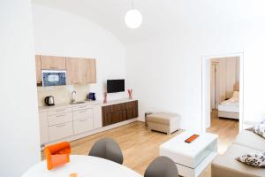 a kitchen and living room with a couch and a table at Vienna Stay Apartments Belvedere in Vienna