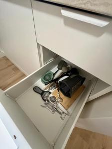 a drawer in a kitchen cabinet with a pair of tools at Bonnie&Beauty apartment in Banská Bystrica