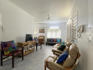 a living room with a couch and a table at Whitehaven 2 in Picnic Bay