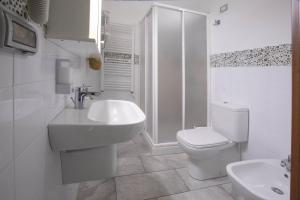 a bathroom with a sink and a toilet and a shower at Etna Sea House in Catania +88 photos