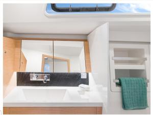 a bathroom with a sink and a mirror at VOILIER 12 Mtres 3 CABINES PROCHE JO MARSEILLE in Marseille