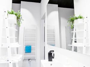 a bathroom with a mirror and a sink at Boom Apartments in Kraków +36 photos
