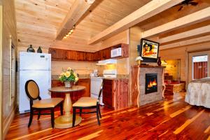 a living room with a kitchen and a fireplace at Mountain Love Nest in Gatlinburg