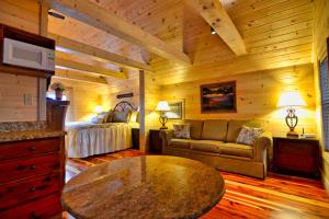 a living room with a bed and a table at Mountain Love Nest in Gatlinburg