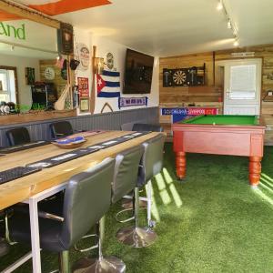 a bar with a table and a pool table at Little Vatson in Pembrokeshire