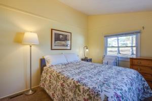 a bedroom with a bed and a lamp and a window at Cozy Huntingdon Escape 19 Mi to Penn State Univ! in Huntingdon