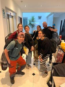 a group of people posing for a picture in a room at The Point Miraflores - Party Hostel in Lima