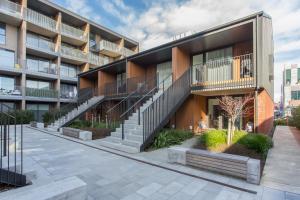 an external view of a building with stairs at Modern Stylish New 3 Mins CBD in Christchurch