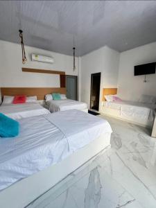 a bedroom with two beds and a flat screen tv at Hotel Casa Cafur in Santa Ana