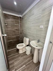 a bathroom with a toilet and a sink at Hotel Casa Cafur in Santa Ana