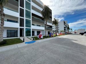a group of santa decorations sitting outside of a building at Loft Marina Cerritos in Mazatlán