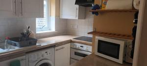 a kitchen with a sink and a dishwasher at Greenwich Homestay in London