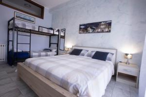 a bedroom with a large bed and two bunk beds at Etna Sea House in Catania
