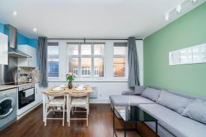 a living room with a couch and a table at Soho Apartments F2 in London