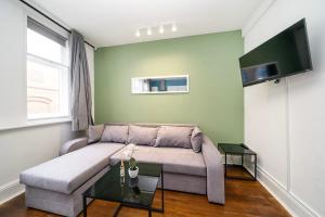 a living room with a couch and a table at Soho Apartments F2 in London