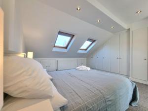 a bedroom with a bed and two skylights at The Loft in London