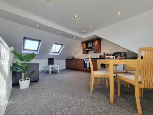 a kitchen and dining room with a table and chairs at The Loft in London