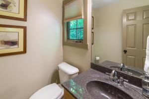 a bathroom with a sink and a toilet and a window at Sparrow Cottage Charming Arts & Crafts Cottage in Black Mountain +19 photos