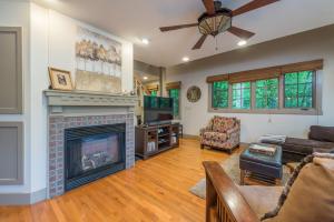 a living room with a fireplace and a tv at Sparrow Cottage Charming Arts & Crafts Cottage in Black Mountain
