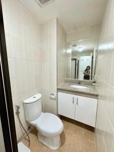 a person taking a picture of a bathroom with a toilet at Caiden's Home in Davao City