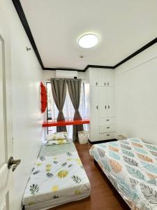 a small bedroom with a bed and a window at Caiden's Home in Davao City