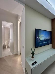 a living room with a flat screen tv on a wall at Interio Apartament PREMIUM in Cortina North in Bucharest