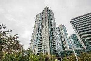 a tall apartment building with two tall buildings at RivetStays - The Neptune in Toronto