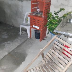 a chair sitting next to a brick oven at à 5 minutos do Parque do Povo in Campina Grande +6 photos