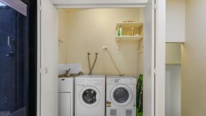 a laundry room with a washer and dryer at The Hide Away in Kalimna