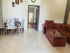 a living room with a couch and a table at Naini House in Nainital