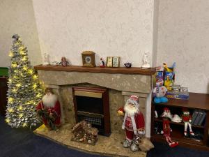 a fireplace with santa clauses and a christmas tree at Big Anthony’s in Greencastle