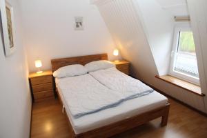 a bedroom with a bed and two lamps on two night stands at Uttumer Mühle Daike in Uttum
