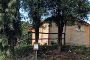 a house with a sign in front of two trees at One bedroom property with enclosed garden and wifi at Falgaroso Da Serra Mortagua in Mortágua