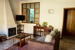 a living room with a couch and a fireplace at One bedroom appartement at Vila Nova de Gaia 100 m away from the beach with wifi in Vila Nova de Gaia