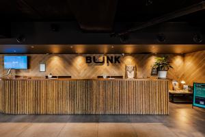 a bar in a restaurant with a wooden wall at Bunk Surfers Paradise 18-35 Backpacker Hostel in Gold Coast
