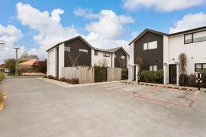 a parking lot in front of a house at Light & Spacious 2Bdrm Townhouse Off Street Park in Christchurch +6 photos