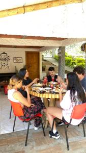 a group of people sitting at a table eating food at La Greca - Casa de Paz in San Agustín