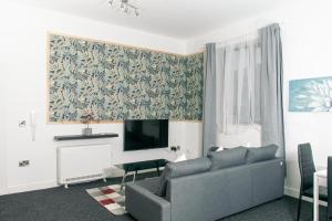 a living room with a couch and a tv at Modern and Spacious 2 bedroom Apartment, Close to Stadiums, Transport links, Free Parking in Manchester