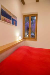 a red rug in a room with a window at Apartment Traces in Split