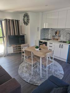 a kitchen and dining room with a wooden table and chairs at Mini Mansion in Auckland