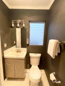 a bathroom with a white toilet and a sink at Beautiful Studio in North Inglewood in Los Angeles