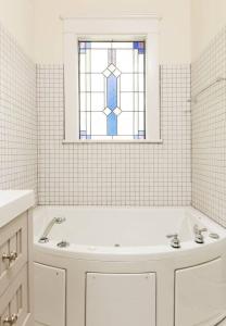 A bathroom at 5BR Historic Midtown Craftsman Home w Jacuzzi