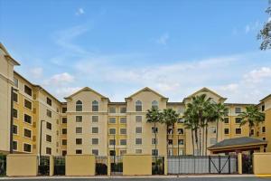 a large building with palm trees in front of it at I-DRIVE SUITES in Orlando