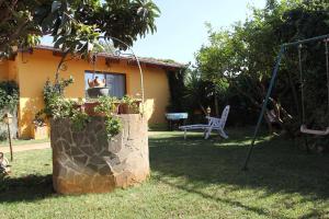 a yard with a swing and a house at Casa Vacanze Margherita in Riola Sardo +17 photos