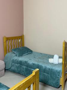 a bedroom with a bed with a green comforter at Coastal Comfort Rentals! in Tangier