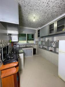 a kitchen with stainless steel cabinets and a stove at Coastal Comfort Rentals! in Tangier