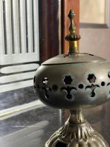 a metal vase sitting on top of a table at Coastal Comfort Rentals! in Tangier